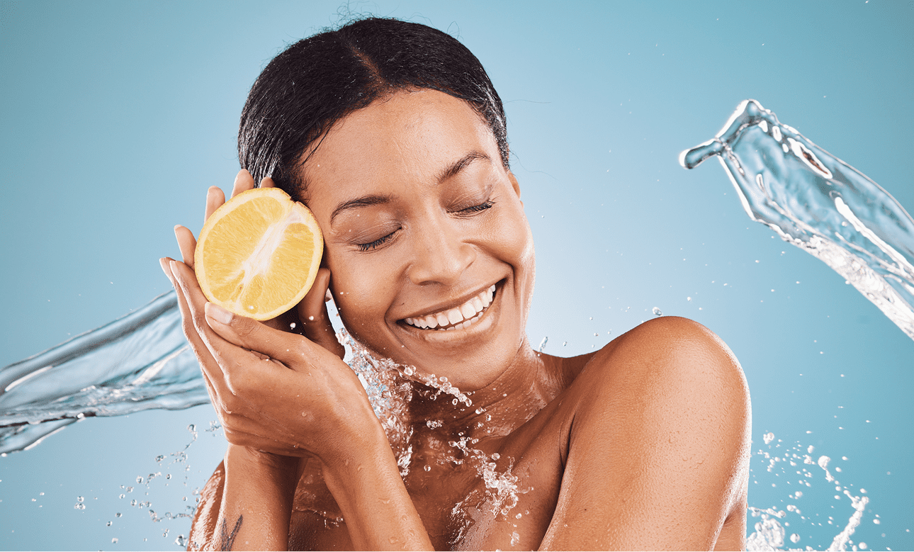 Joyful woman holding lemon against water backdrop