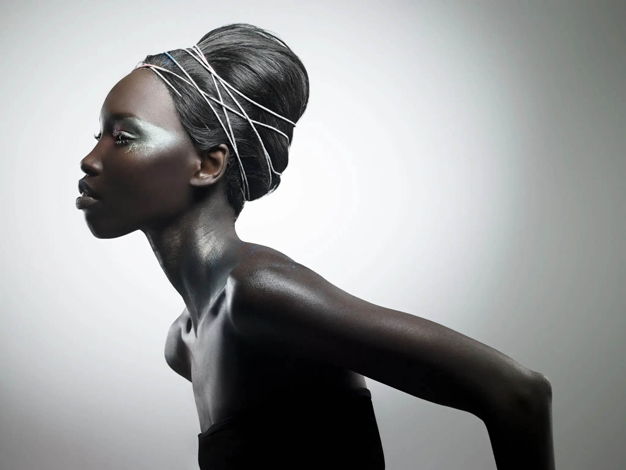 Profile of woman with styled hair.