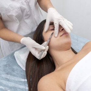 Woman receiving facial injection at clinic.