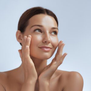 Woman touching face with relaxed expression.