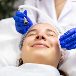Woman receiving facial skincare treatment.